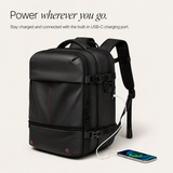A black laptop backpack with a built-in USB-C charging port, shown with a smartphone connected via a white cable. The image includes the text 'Power wherever you go.