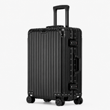 A black hard-shell spinner suitcase with a vertical ribbed design, telescoping handle, and four wheels, shown on a light gray background.