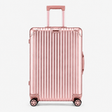 A metallic pink hard-shell suitcase with vertical grooves, an extended telescoping handle, and four spinner wheels, shown against a plain light gray background.