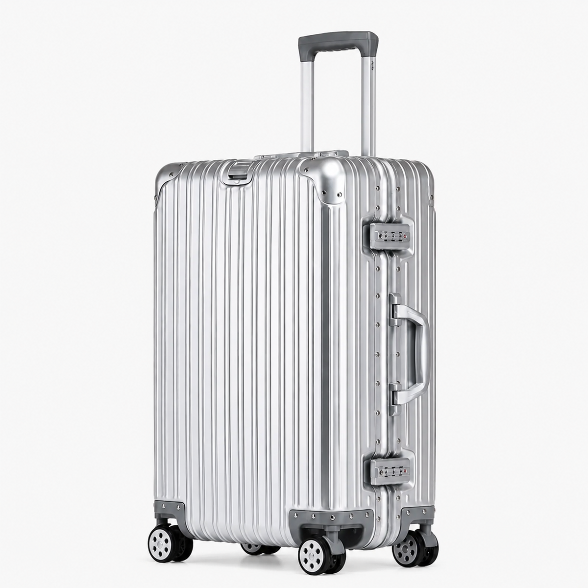 A silver aluminum ribbed hard-shell suitcase with four spinner wheels, an extended telescopic handle, and dual lock latches, shown on a light gray background.