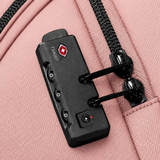 Close-up of a pink fabric bag with a TSA-approved combination lock attached to the zipper, showing the lock's dials and red logo.
