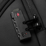A close-up of a black TSA-locked luggage zipper padlock attached to a black textured bag with a zipper.